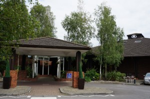 a building with a roof and a parking lot