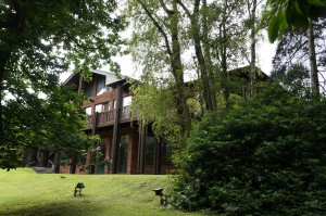 a house with a large lawn and trees