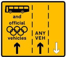 a yellow road sign with black text
