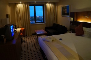a hotel room with a bed and a desk