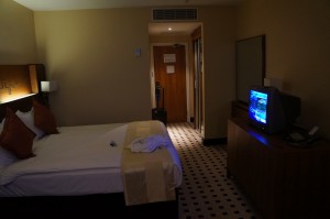 a room with a bed and a television
