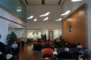 people sitting in a room with chairs and a table