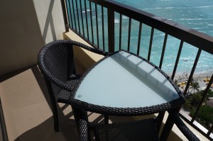 a table and chair on a balcony