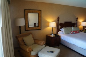a hotel room with a bed and a chair