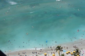 a beach with people swimming in the water