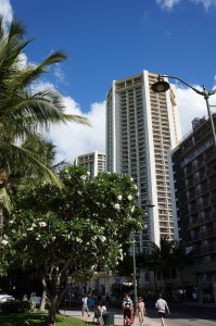 a tall building with palm trees