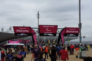 a group of people walking in front of a large sign