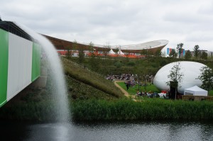 a water fountain in front of a lake