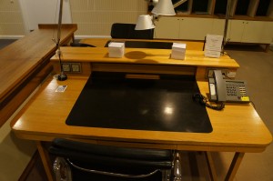 a desk with a phone and a chair