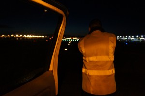 a man looking out of a car door at night