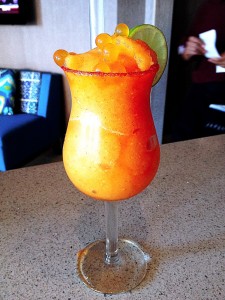 a glass with orange drink and lime