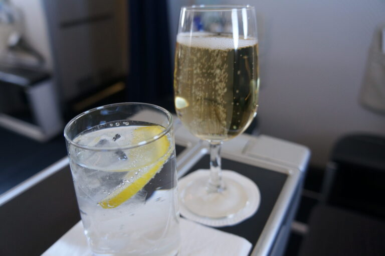 a glass of wine and a glass of water on a tray
