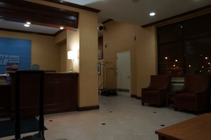 a room with a reception desk and chairs