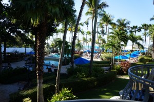 a view of a resort with palm trees and a pool