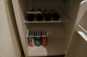 a refrigerator with cans of soda