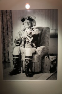 a man in a garment sitting in a chair