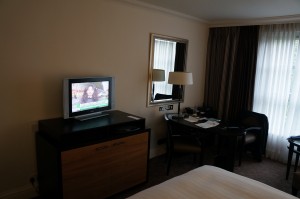 a tv on a stand in a hotel room