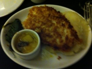 a plate of food with a small cup of sauce