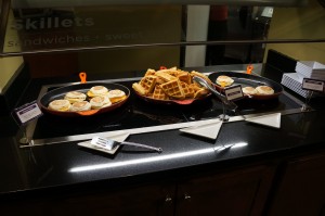 a buffet table with plates of food