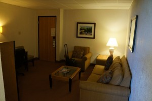 a living room with a couch and a lamp