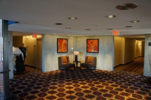 a room with chairs and a lamp