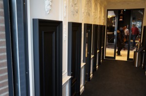 a long hallway with black doors