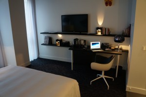 a bedroom with a bed and a desk