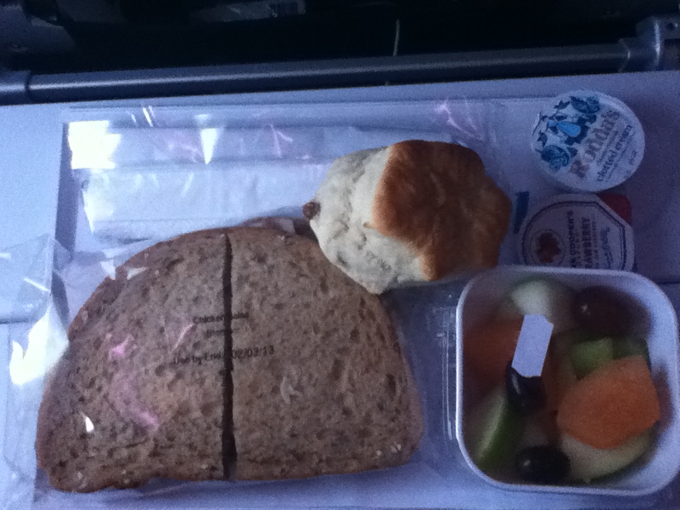 a sandwich and fruit in a container