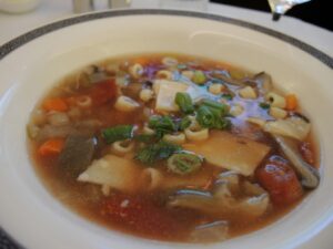 a bowl of soup with noodles and vegetables