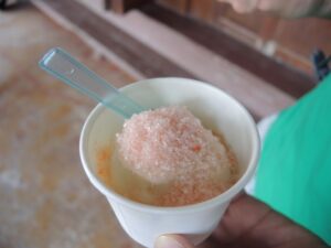 a hand holding a cup of ice cream