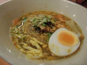 a bowl of soup with an egg