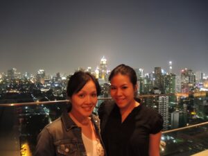 a couple of women standing on a rooftop