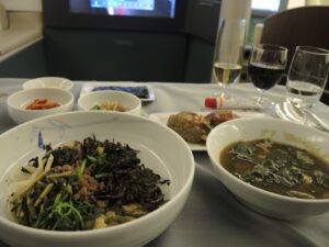 a table with plates of food and glasses of wine