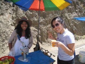 a couple of women standing under an umbrella