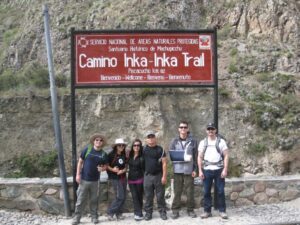 a group of people standing in front of a sign
