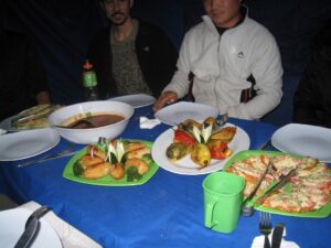 a man sitting at a table with plates of food