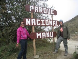 a couple standing next to a sign