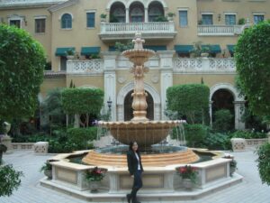 a woman standing in front of a fountain