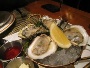 a plate of oysters and lemons