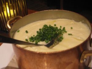 a pot of soup with a spoon