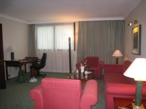 a room with red couches and a table