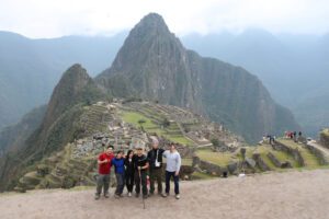 a group of people standing on a mountain
