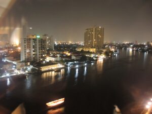 a city at night with water and boats
