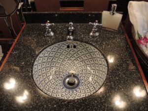 a sink with faucets in a bathroom