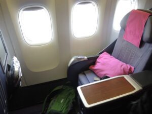 a seat and a bag on the side of an airplane