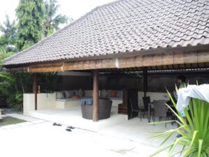 a man standing under a roof