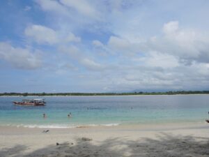 a beach with a boat in the water