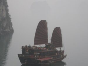 a boat with a large wing on the water