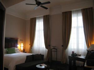 a room with a bed and a fan