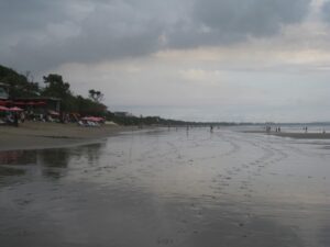 a beach with people walking on it